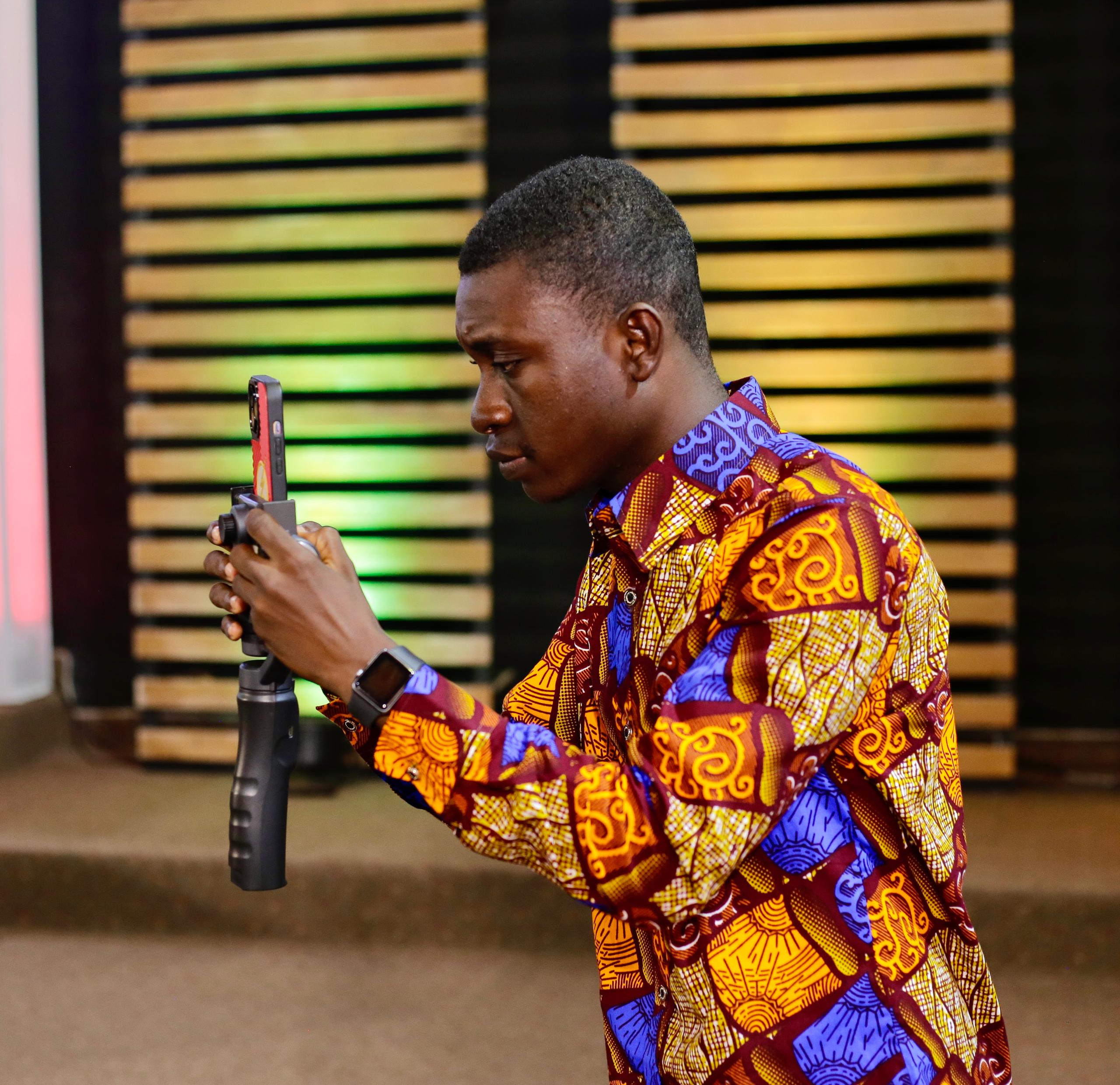 Mrr_Asiedu holding his phone on a gimbal while filming
